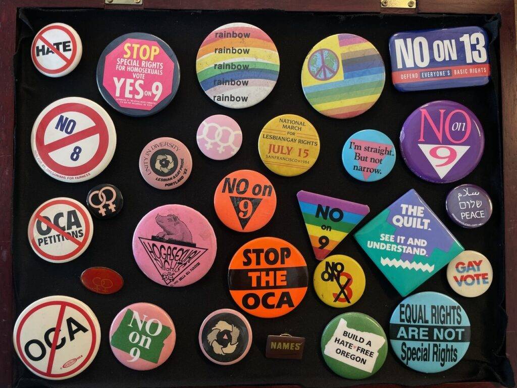 Multiple Buttons from LGBTQIA+ Events & Anti-LGBTQIA+ Campaigns, 1982-2004.
